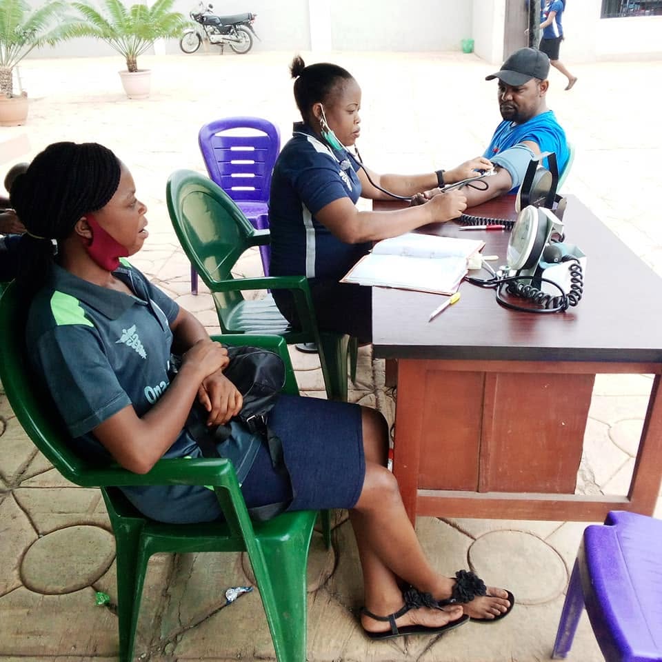 A nurse checking a patient's blood pressure at an outreach